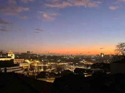 a view of a city at sunset at Sol Do Porto - 2 bed Penthouse Luis Bridge view in Porto