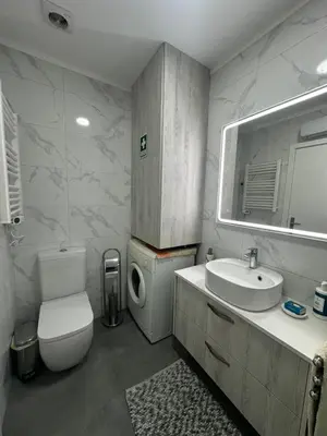 a bathroom with a toilet and a sink and a mirror at SP Douro Apartment in Vila Nova de Gaia