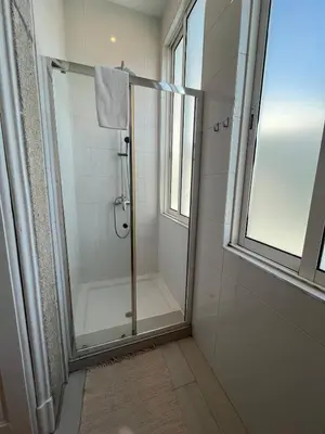 a shower with a glass door in a bathroom at Studio in a typical Porto house in Porto