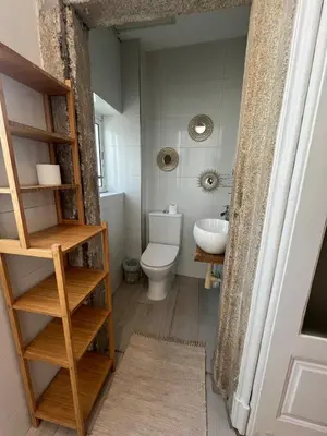 a small bathroom with a toilet and a sink at Studio in a typical Porto house in Porto