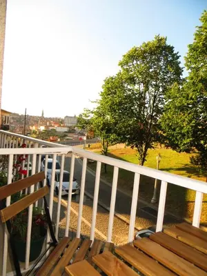 a wooden bench sitting on a balcony overlooking a street at House T3 in Vila Nova de Gaia