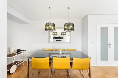 a dining room with a table and yellow chairs at GuestReady - Cosy Porto retreat in Porto