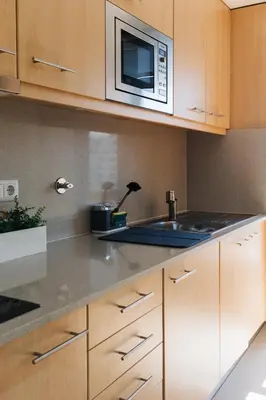 a kitchen with a sink and a microwave at Dragon View Watch the Game in Porto