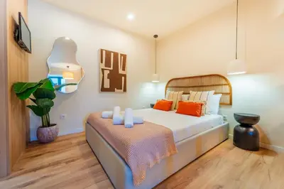 a bedroom with a large bed with orange pillows at Douro Prestige Studio in Vila Nova de Gaia