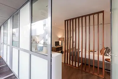 a bedroom with a bed and a glass wall at Carlos Alberto Apartment in Porto