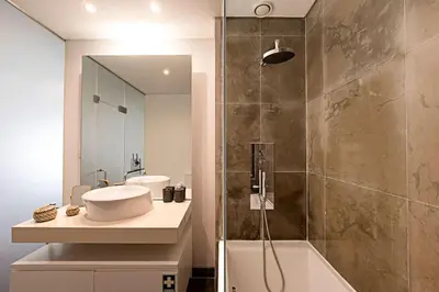 a bathroom with a sink and a shower at Carlos Alberto Apartment in Porto