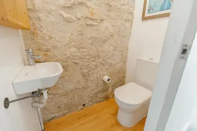 a bathroom with a toilet and a sink at Urban Refuge 4BD by Vacationy in Porto
