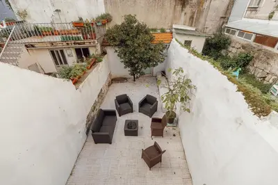 an overhead view of a patio with chairs and tables at Urban Refuge 4BD by Vacationy in Porto