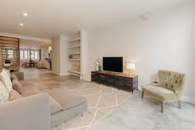 a living room with a couch and a television at Urban Refuge 4BD by Vacationy in Porto