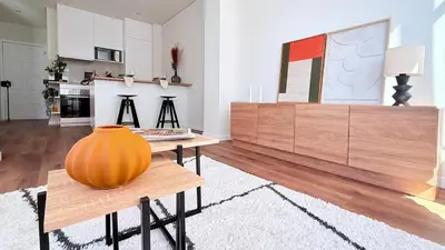 a living room with a large orange vase on a table at Essence Santa Catarina Flat in Porto