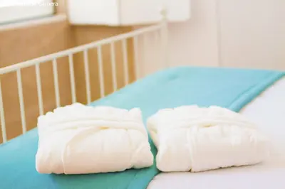 two white towels sitting on top of a bed at Charming Apartments in Historic Centre - Inside Porto Apartments 