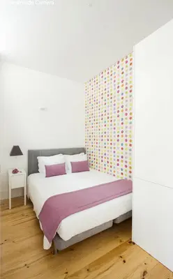 a bedroom with a bed and a wall at Charming Apartments in Historic Centre - Inside Porto Apartments 