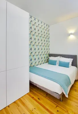 a bedroom with a bed with blue pillows at Charming Apartments in Historic Centre - Inside Porto Apartments 