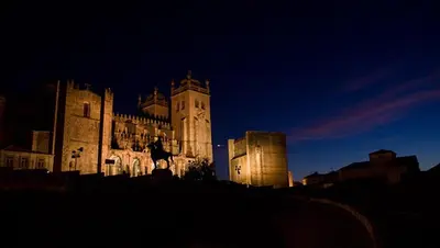 a large building with a clock tower at night at Cativo Flat in Porto