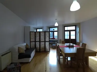 a living room with a table and a dining room at Loft Taipas in Porto