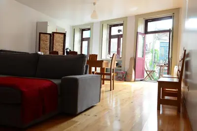 a living room with a couch and a table at Loft Taipas in Porto