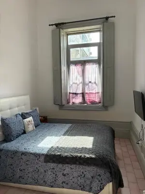 a bedroom with a bed and a window at Residência Céu Azul in Porto