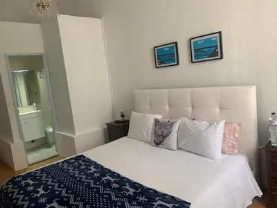 a teddy bear sitting on top of a bed at Residência Céu Azul in Porto