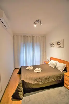 a bedroom with a bed with two towels on it at Sta. Catarina Home in Porto