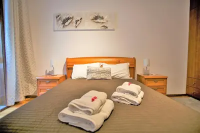 a bedroom with a bed with towels on it at Sta. Catarina Home in Porto