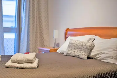 a bed with two towels sitting on top of it at Sta. Catarina Home in Porto