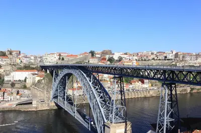 a bridge over a river with a city in the background at Sta. Catarina Home in Porto