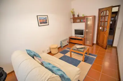 a living room with a couch and a tv at Sta. Catarina Home in Porto