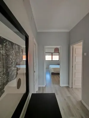 a room with a door and a bedroom with a bed at Baixa24 - Bolhão Apt with Sunset Rooftop in Porto