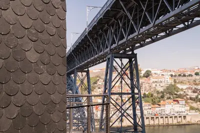 a bridge over a river with a city in the background at Oh! Porto Apartments in Vila Nova de Gaia