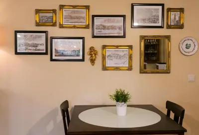 a dining room with a table and framed pictures on the wall at Charming Antas House in Porto