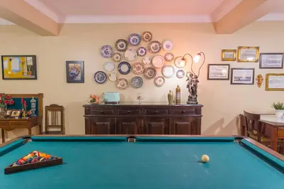 a pool table in a room with plates on the wall at Charming Antas House in Porto