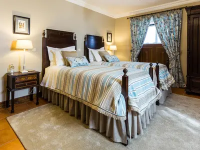 a bedroom with a large bed and a window at Charming Antas House in Porto