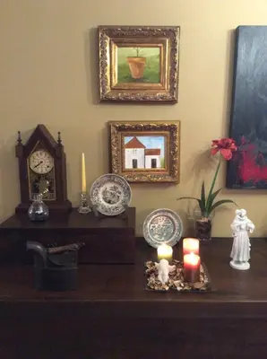 a room with a table with a clock and candles at Charming Antas House in Porto