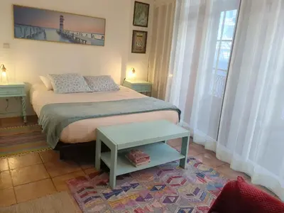 a bedroom with a bed and a table on a rug at Ribeira Smart Suite in Porto