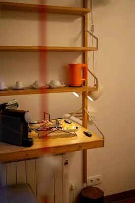 a kitchen with a counter with a stove and shelves at Fil's Place in Porto
