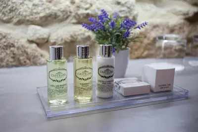 three bottles of moisturizers sitting on a glass tray at Belomont52 Guest House in Porto