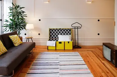 a living room with a couch and a tv at Studio 77 in Porto