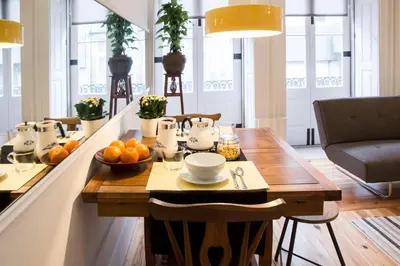 a dining room with a table with a bowl of oranges at Studio 77 in Porto
