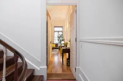 a hallway with stairs leading to a dining room at Studio 77 in Porto
