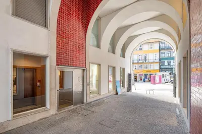 an empty alley with arches in a building at VIVA Aliados Spacious & Bright Flat in Porto