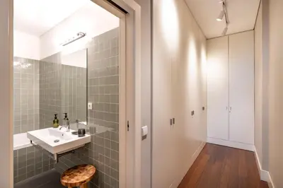 a bathroom with a sink and a mirror at VIVA Aliados Spacious & Bright Flat in Porto