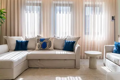 a living room with a couch and some windows at Feel Porto Vintage Townhouses in Porto