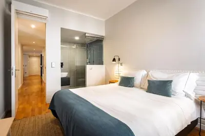 two white beds sitting next to each other in a room at Feel Porto Vintage Townhouses in Porto