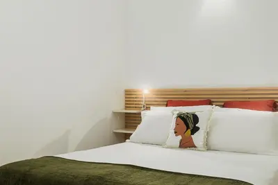 a bedroom with a bed with white pillows at Flores Street Apartments in Porto