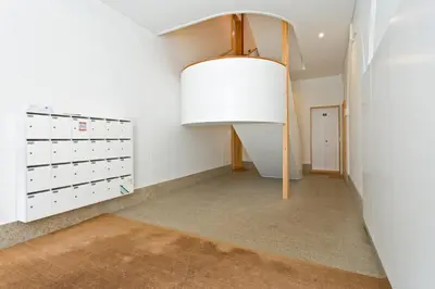 a hallway with a vaulted ceiling and a large lamp at Flores Street Apartments in Porto