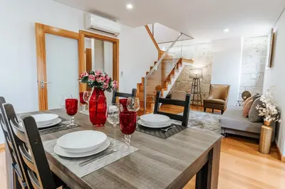 a dining room with a table with red wine glasses at Authentic Porto Apartments in Porto
