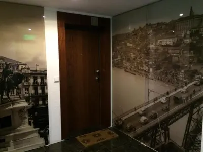 a hallway with a door and a wall with a mural of a city at I love alegria in Porto