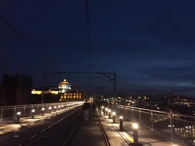 a group of lights on a bridge at night at I love alegria in Porto
