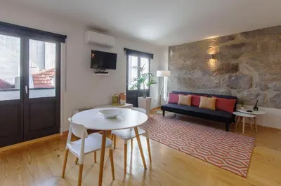 a living room with a table and a couch at Oporto Local Studios in Porto