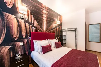 a bedroom with a bed with a painting on the wall at Lounge Inn Guest House in Porto